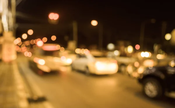 vintage tone image of blur street bokeh with colorful lights in night time for background usage .