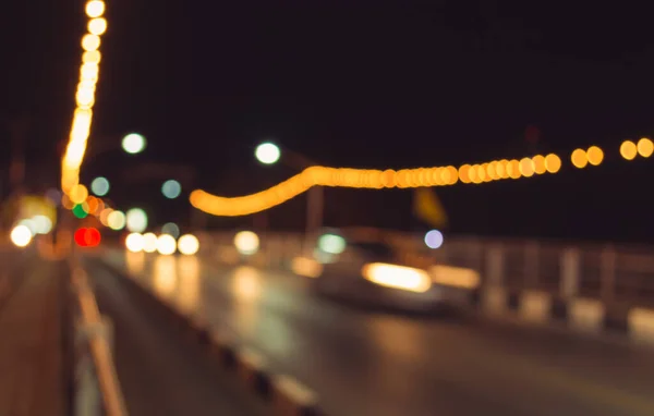 image of blur street bokeh with colorful lights in night time for background usage . (vintage tone)