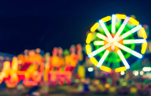 Abstract blur image of theme park on night time for background usage. (vintage tone)