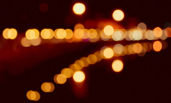 image of blur street bokeh with colorful lights in night time for background usage . (vintage tone)