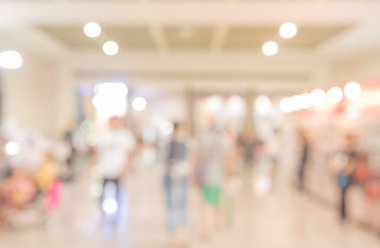 Alışveriş merkezinde veya sergi salonunda arka plan kullanımı için Bokeh ile yürüyen insanların soyut bulanık görüntüsü .