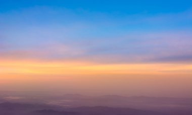 Akşam vakti gökyüzünü görmek için uçak penceresinden bak.