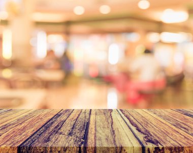 Klasik ton ahşap masa ve arka plan kullanımı için Bokeh ile kafeterya veya restoranın bulanık görüntüsü.