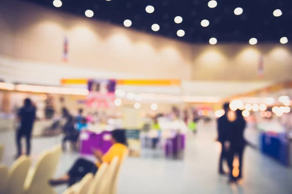 blur image of booth at the fair in the wide and modern hall for background.