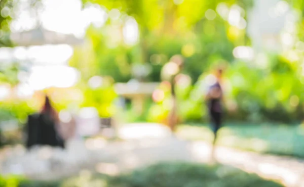 image of blur outdoor restaurant on day time with green tree bokeh for background usage .