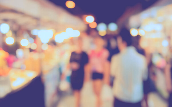 blurred image of  Night festival on street  with bokeh for background usage . (vintage tone)