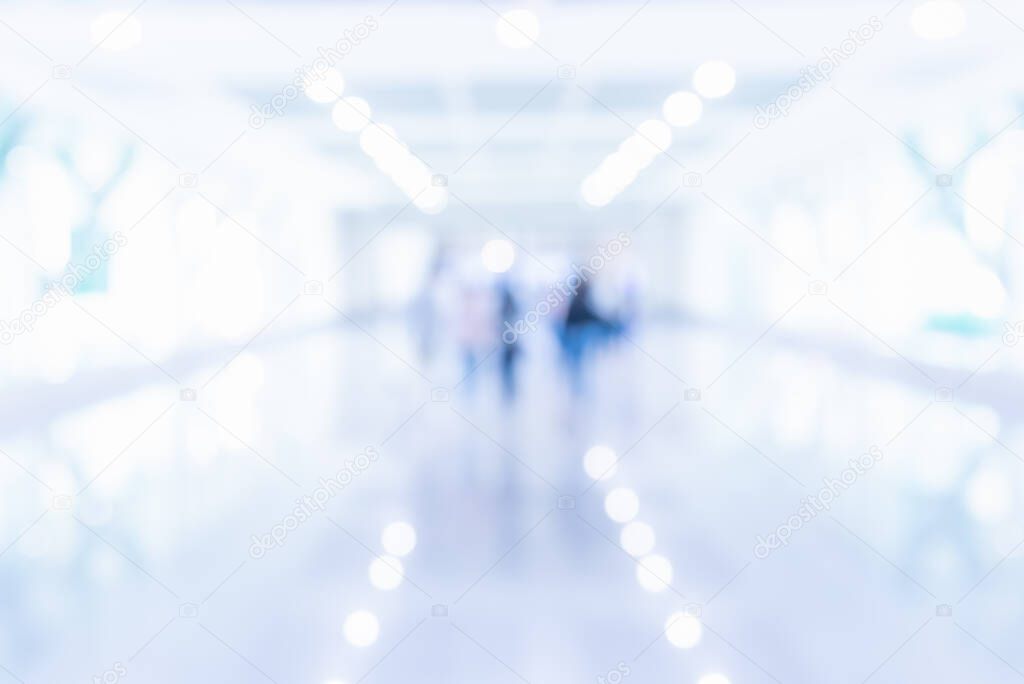 Abstract blur image of People standing in office hall with bokeh for background usage.