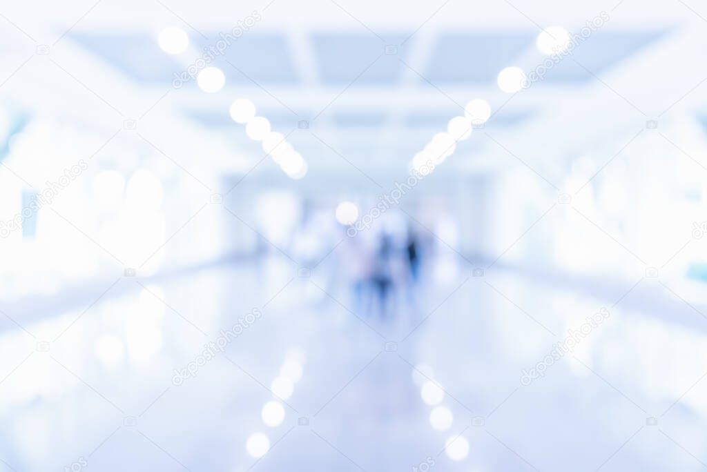 Abstract blur image of People standing in office hall with bokeh for background usage.