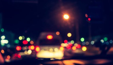 Arka plan için gece vakti trafik sıkışıklığından gelen bokeh ışıkları olan içerideki arabaların klasik ton bulanık görüntüsü .