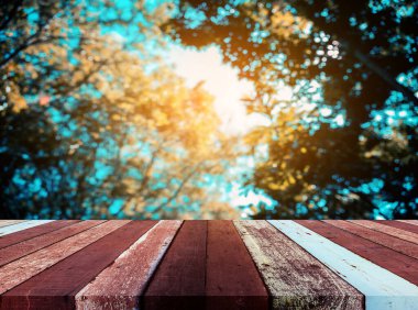 Ahşap tablo ve klasik ton görüntüsü arka plan kullanımı için güneş alan soyut Bokeh yeşil ağaç.