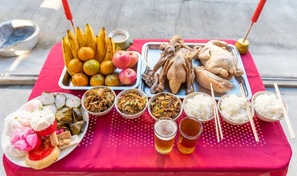 Food on the table for gods worshiping Chinese beliefs, consisting of chicken, duck, fried rice, rice, tea, fruit, various desserts in the China New Year.