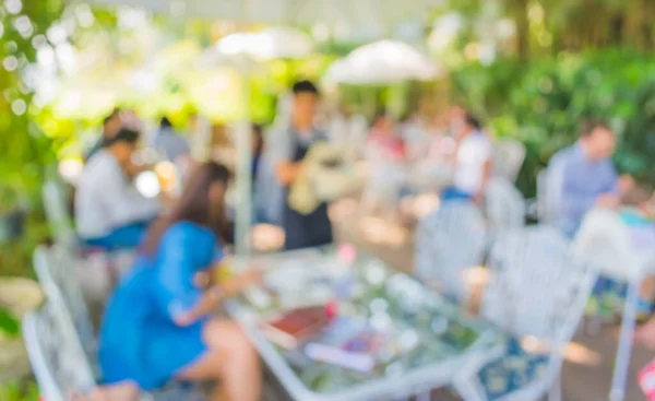 image of blur outdoor restaurant on day time with green tree bokeh for background usage .