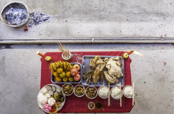 Food on the table for gods worshiping Chinese beliefs, consisting of chicken, duck, fried rice, rice, tea, fruit, various desserts in the China New Year.