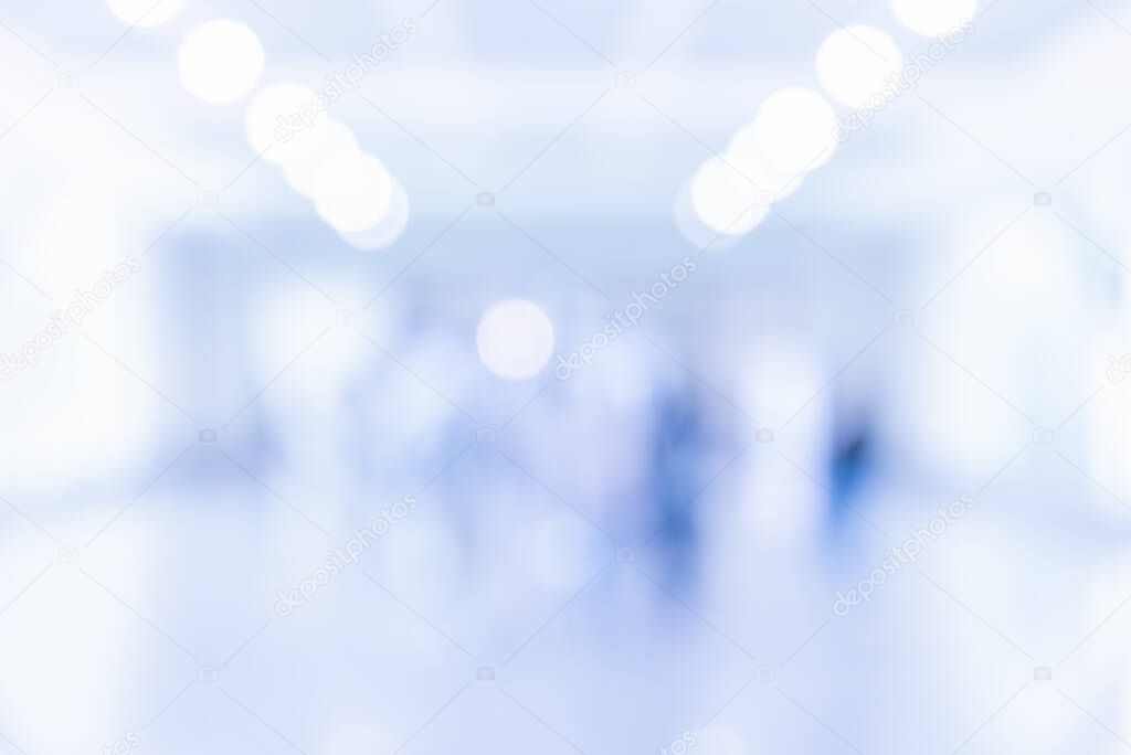 Abstract blur image of People standing in office hall with bokeh for background usage.