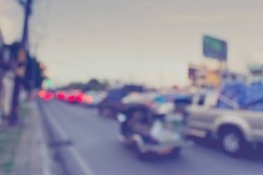 Arka plan kullanımı için akşam vakti yolda bulanık bir araba görüntüsü. (Klasik ton))