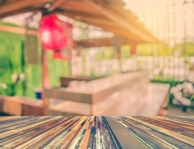 Eski tarz dekorasyon restoranındaki ahşap masa ve soyut bulanık suşi tezgahının bulanık görüntüsü.