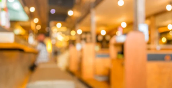 blur image of japan restaurant and lady customer waiting for her meal for background usage.