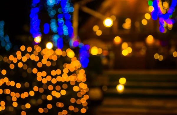 image of blur restaurant and Christmas light in night time for background usage .