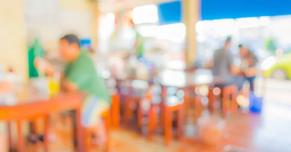 image of blur people at food stall with bokeh ;  for background usage .