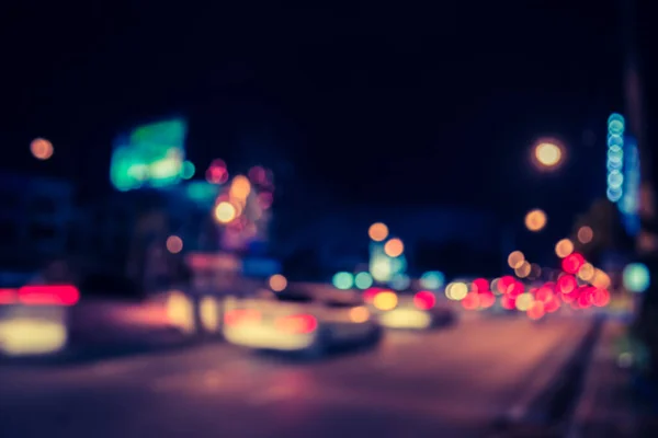 image of blur car on road in night time for background usage. (vintage tone)