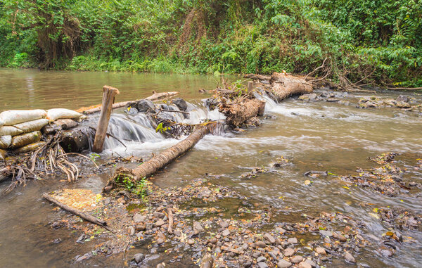 weir(small dam) across the river on day time