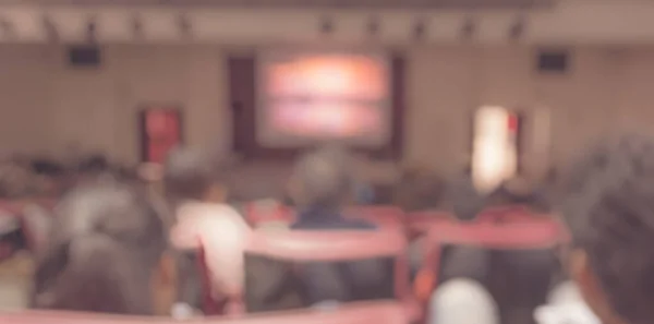 vintage tone Blurred image of people in auditorium , Abstract blur for background usage.