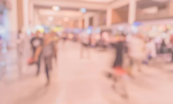 Blurred people walking at hallway in airport for background usage . (vintage tone)