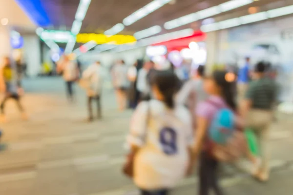 blurred image of shopping mall and people for background usage .