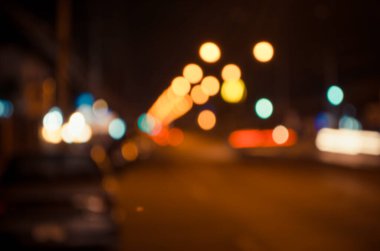Arkaplan kullanımı için gece vakti ışıklandırmalı bulanık sokak bokeh görüntüsü .