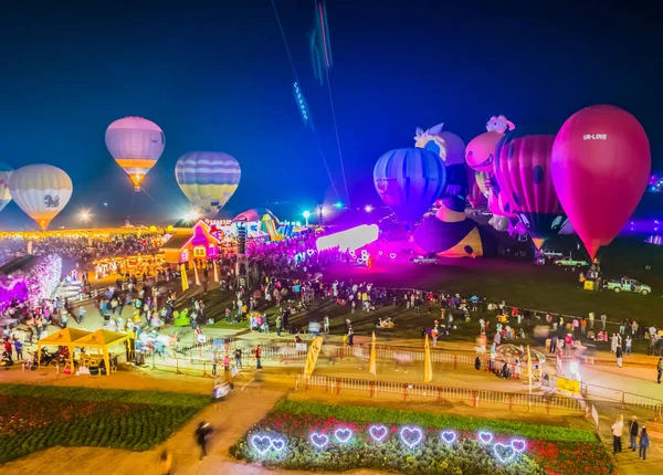 CHIANG RAI, THAILAND - FEB 13, 2016: Colorful of hot air balloons and people in The International Balloon Festival 2016 at Singha Park Chiang Rai, Thailand.(blur on people and Balloon blur from movement).