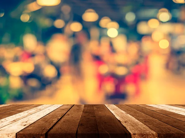 wood table and restaurant blur background with bokeh image .