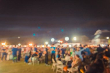 vintage tone blur image of people in night festival on street with bokeh for background usage .