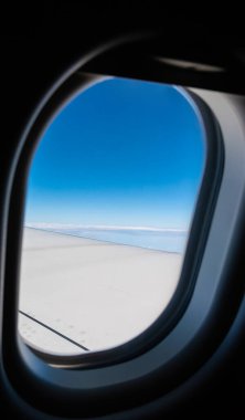 image of View from plane window to see the sky and wing for background.(vertical)