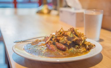 image of rice with fried sausage topped with Japanese style hot and spicy yellow curry.