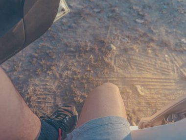 vintage tone close up image of young man get out from car to start running to the road.