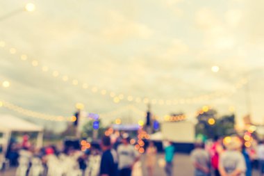 vintage tone blur image of people in festival on street with bokeh for background usage .