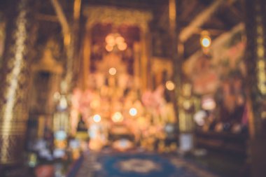 vintage tone Image of abstract blur hall of buddhist temple with bokeh for background usage.