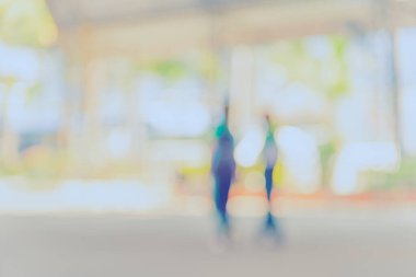 Abstract blur image of people walking on street with bokeh for background usage . (vintage tone)