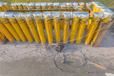 tube fill with fireworks gunpowder and electric wire on ground.