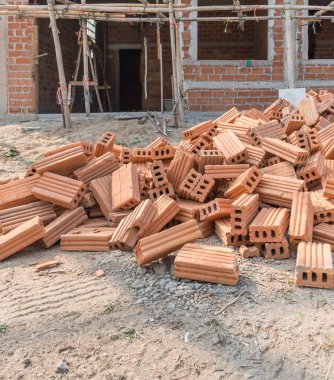 vintage tone image of building under construction and bricks on day time with copy space for background usage.