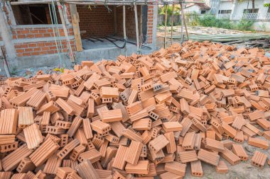 vintage tone image of building under construction and bricks on day time with copy space for background usage.
