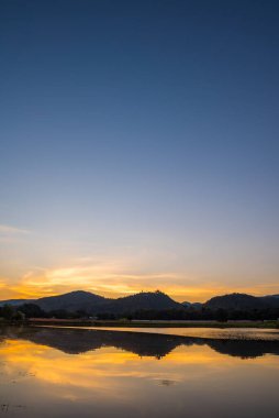 silhouette shot image of mountain and sunset sky in background on twilight time.(vertical)