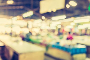 image of blur people at food stall in market with bokeh for background usage.(vintage tone)