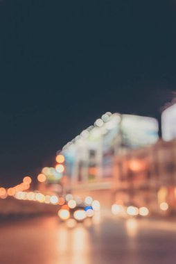 Vertical abstract blur image of Night  light bokeh on street for background usage. (vintage tone)