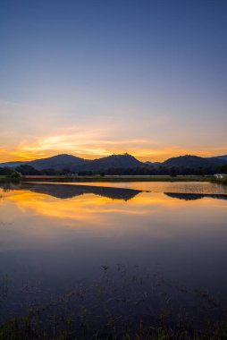 silhouette shot image of mountain and sunset sky in background on twilight time.(vertical)