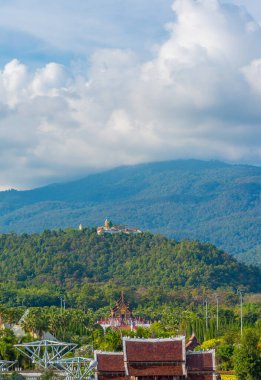 Old temple and holy Buddha statue on mountain at Wat Phra That Doi Kham temple, Chiang Mai , Thailand.(vertical)