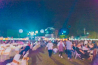 vintage tone blur image of people in night festival on street with bokeh for background usage .