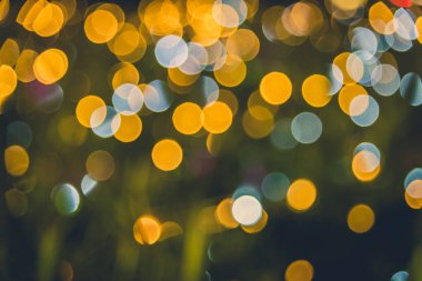 image of blurred bokeh background with warm colorful lights in garden. (vintage tone)