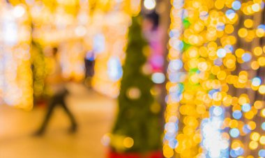 vintage tone blur image of people walking in night festival with bokeh for background usage .