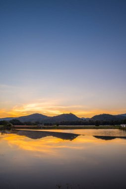 silhouette shot image of mountain and sunset sky in background on twilight time.(vertical)